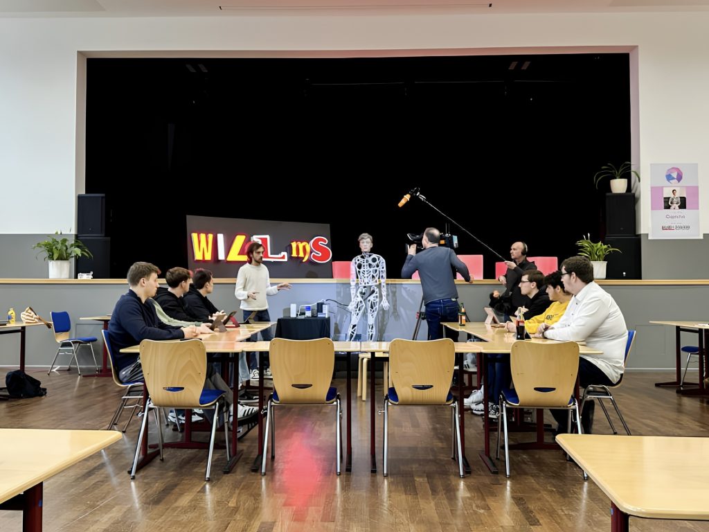 Captcha, a humanoid robot, stands before students as debate moderator at WILMS, a high school in Delmenhorst, Germany