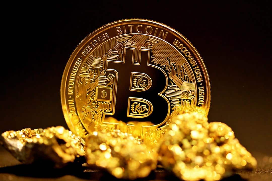 a bitcoin sitting on top of a pile of gold nuggets - A single bitcoin surrounded by raw gold pieces., tags: $30,000 time june - unsplash