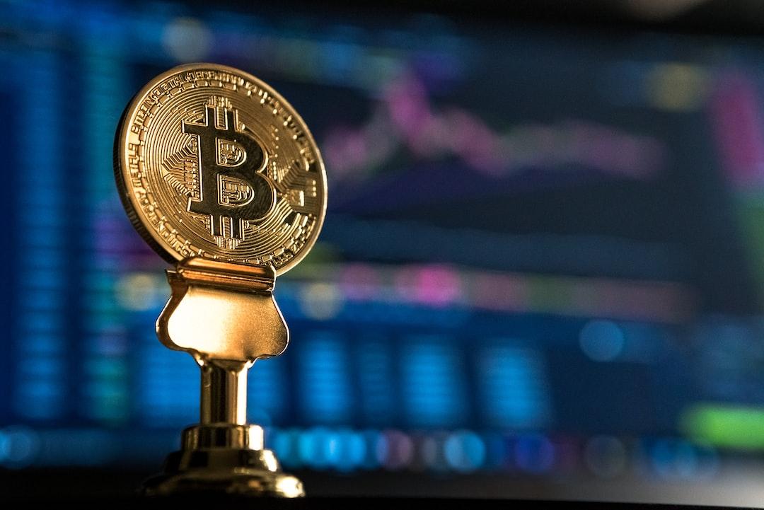 selective focus photo of Bitcoin near monitor - After watching my portfolio in usd drop by over 50% in one day I realized it wasn’t usd that is important, it is the btc ratio. You see, I’m holding all altcoins, which help me gain more bitcoin as they rise in price. End of the day, I believe Bitcoin is king. This photo represents Bitcoins ratio to altcoins (seen in the trading chart behind)., tags: interest - unsplash